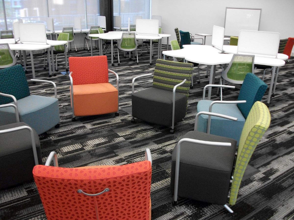 Several clusters of tables and chairs in the Library  Learning Terrace